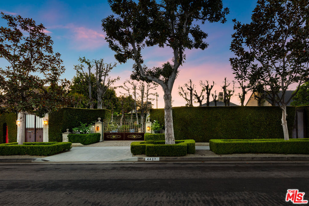 Curated Celebrity Toluca Lake Estate. Very private, gated, and remodeled European-style oasis. This magnificent residence boasts procured items from around the globe incl. tumbled stone, ceiling beams and chandeliers from France, handmade stainless steel doors, windows and pergolas, a converted conservatory seat from India (orig. a balcony), and a mailbox brought from Hong Kong! The 3101 sq. ft. 4+2.5 has a formal fireside living room, library w/wet bar, fireplace and built-ins, and a gourmet kitchen where epicurean memories await w/warm chestnut cabinetry, Mugnaini pizza oven, zinc island top, stone countertops, tumbled stone backsplashes, Turbo Chef oven, ice maker and breakfast area. A secluded outdoor lounge incl. a fire table and tranquil sounds from the fountains. Whimsical stone frogs shoot streams of water into the pool--surrounded by pea gravel, citrus trees, and privacy hedges on a 11410 sq. ft. lot. Converted garage houses built-in cabinets, wine refrigerator that holds approximately 1000 bottles all secured with custom garage doors.