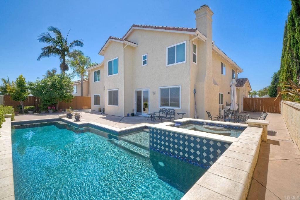 Ocean Hills Oasis with Stunning Views – Available Now! This spacious 4-bedroom, 3-bath home features 2 additional bonus rooms and includes a downstairs bedroom and full bath, perfect for guests or multigenerational living. The chef-inspired kitchen boasts granite counter with ample counter space and storage, brand-new KitchenAid stainless steel appliances including refrigerator and dishwasher and a dining nook. Enjoy a grand great room with soaring ceilings, a cozy fireplace in the family room, and a formal dining room. The generous primary suite includes an attached office, ideal for remote work. Upstairs bonus room offers flexible space for an office, playroom, or additional bedroom. Home includes new luxury vinyl plank flooring, new blinds, interior laundry room with washer/dryer, 3-car garage with EV charger, solar panels, central AC, and alarm system. The beautifully landscaped backyard features mature avocado and persimmon trees, and a sparkling saltwater pool and spa with incredible views that are ideal for outdoor entertaining. Gardener and pool maintenance included! Pets considered with additional pet deposit! Close to shopping, dining, and Palomar Airport. Minimum 1 year lease.