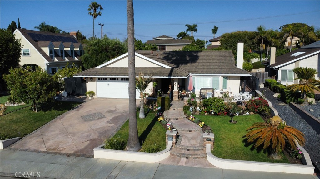 Stunning single-story ranch home in south HB. This beautifully upgraded single-level 4-bedroom, 2-bathroom home sits on an oversized 9,122 sq ft lot, featuring impressive curb appeal with custom pavers, a stone wall, a serene water fountain, and a striking new wrought iron front door. Step inside to a bright and open floor plan featuring vaulted ceilings, skylights, elegant crown molding throughout, and both formal living and family rooms. The remodeled chef’s kitchen is complete with stainless steel appliances, quartz countertops, a double oven, a large center island, farm-style sink, recently refreshed shaker-style cabinetry, reverse osmosis alkaline water system AND soft water system throughout the house. The primary suite offers cathedral ceilings, slider to the backyard, a large walk-in closet with access to an expansive finished out attic space with lighting and flooring - an amazing space for all of your holiday decor - a remodeled en-suite bath featuring dual sinks, gorgeous granite countertops, luxurious soaking tub, vaulted ceiling, deluxe remote-controlled skylight and brand new 'smart' mirror. All bedrooms feature beautiful hardwood flooring, with wide-plank hardwood in the living room, and travertine tile in the kitchen, family room, and bathrooms. Both bathrooms have been thoughtfully updated, the home has energy efficient Pella windows with built-in blinds, a metal roof, central AC, and ceiling fans in every room. Outside, the fully fenced backyard offers endless potential for a pool or ADU, and includes a new shed—perfect for a home gym, office, or extra storage—along with fruit trees and a manicured lawn that add a sense of peace and harmony. Additional upgrades include new pet-proof security screens in kitchen, primary bedroom and front door, fresh stucco around the entire home and an attached garage outfitted with Closet World built-ins, large attic storage space, epoxy flooring, and a new garage door. Located just minutes from local parks, shopping, dining, and the beach, this is a rare opportunity to own a thoughtfully improved home where no detail has been overlooked.
