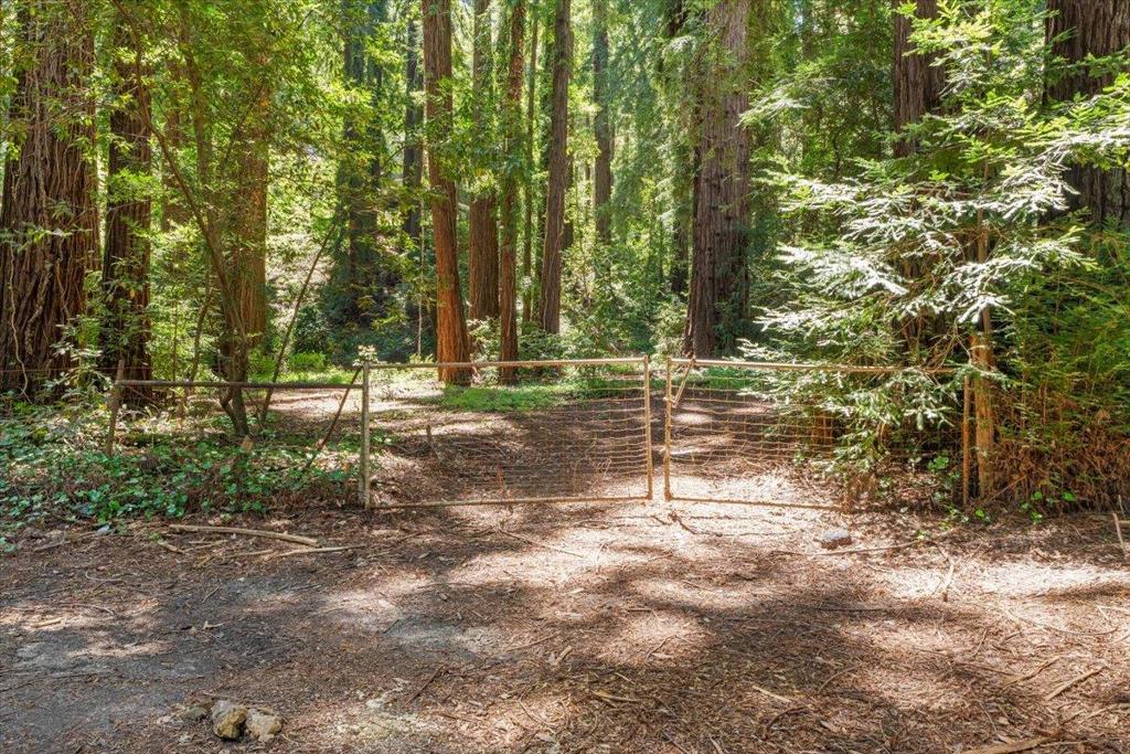 Centrally located in the Summit Road community, this idyllic building lot is nestled among majestic redwoods and offers an ideal commute location, approximately 10 minutes to downtown Los Gatos. The property is served by award-winning Los Gatos schools: Loma Prieta Elementary, C.T. English Middle School, and Los Gatos High School. The seller has completed the following toward building approval, including site approval, fire department approval, an approved septic system, geotechnical reports, and a letter from the water district. Buyer to verify site approval and all requirements with Santa Clara County.
