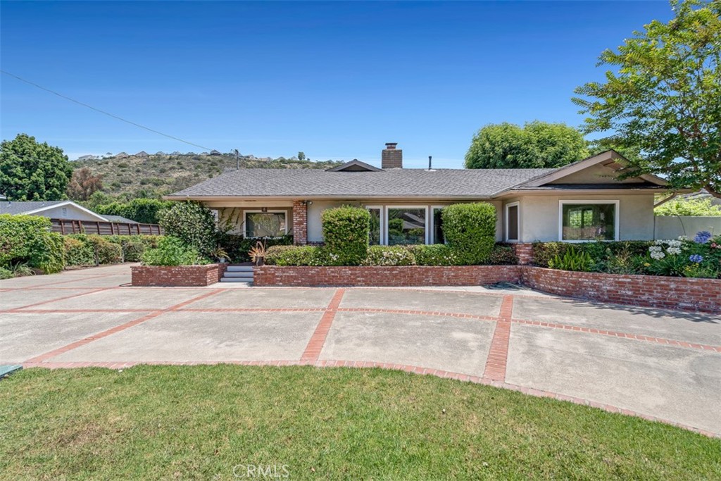 Nestled in North Tustin’s prestigious 92705 area, this immaculate single-story ranch boasts 4 spacious bedrooms and 3 fully remodeled bathrooms across 3,153?sq?ft. The inviting floorplan features distinct living and family rooms connected by a two-way fireplace, plus a formal dining area ideal for entertaining. The updated galley kitchen shines with granite counters and ample cabinetry. The expansive master suite includes an ensuite bath and an adjacent den/office. A large game/bar room opens to the outdoor patio and backyard. Additional highlights include a three-car garage with pull-through access, newer windows, central A/C, and proximity to Panorama Elementary.
