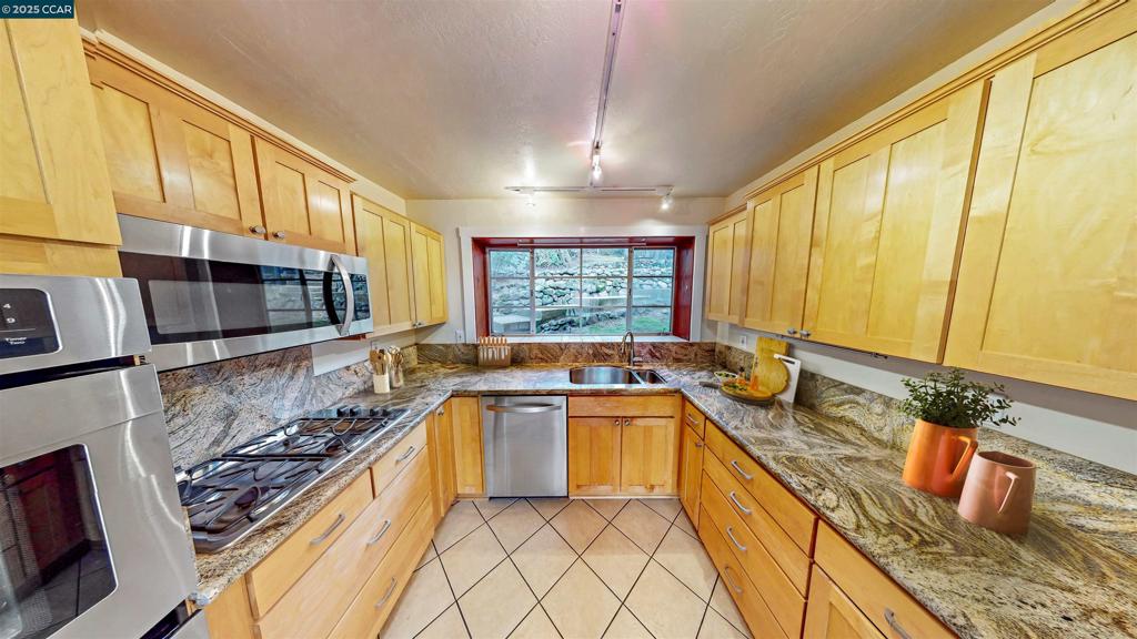 Two Units. 3 bd 1.5 bath main house + lower level studio apartment. Also listed as a single family detached home on MLS. Charming ahoe-cabin-like home with beautiful rustic finished yet remodeled and refined throughout. Stone fireplace, hardwood floors, wood windows plus exposed wood beam ceilings and classic wood paneling Nicely appointed remodeled kitchen with natural wood cabinets and recently upgraded stainless steel appliances including gas cooktop, double ovens, built in microwave and dishwasher. Built in 1925, this 1538 square foot main house has three spacious bedrooms, one on main level and two others on the top level with full bathroom. Lower studio offers a private entrance, a versatile and efficient 438 square foot floor plan with tile floors, new paint, full kitchen and separate bathroom. The oak-studded lot captures the essence of nature, including filtered view of downtown Oakland and stamped concrete walkways, stairs and patios throughout the property. A spacious two car garage/storage unit is located on the upper portion of the lot. Just minutes to downtown Montclair with grocery stores, shops and restaurants plus easy access to highway 13 and a quick connection to hwy 24.
