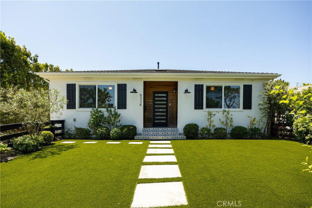 Located on a quiet, tree-lined street in North Kentwood, 6334 W 80th Place combines timeless curb appeal with updated modern style. A wood-accented entry with patterned tile steps is framed by manicured landscaping and eco-friendly turf, leading into an open layout with wide-plank hardwood floors, designer lighting, and thoughtfully selected finishes. The kitchen features quartz countertops, custom wood cabinetry, stainless steel appliances, and a spacious peninsula, with a natural flow into the dining and living areas ideal for both entertaining and everyday living. The home offers four bedrooms and three full bathrooms, including two en suites. The primary suite opens to the private backyard and includes a dual vanity bath, walk-in shower, and custom-designed closet. Additional bedrooms are well-finished, with one suited for a home office or creative space. Outside, enjoy a yard surrounded by mature hedges and fruit trees, plus a detached two-car garage with French doors. Added features include a Tesla EV charger, motorized window treatments, central air conditioning, and solar panels.