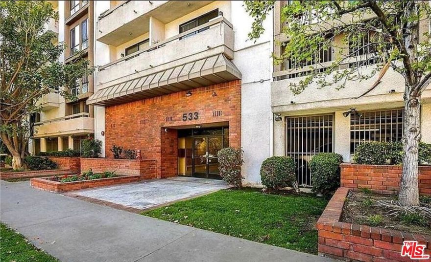 Welcome to this bright and beautifully updated top-floor front corner unit, offering nearly 1,000 sf of modern living space with sweeping North-East facing views of Hollywood and DTLA. Located west of Western and north of Wilshire, this spacious 2bd+2ba condo features high ceilings, new wide-plank laminate flooring, and new paint throughout. The remodeled kitchen showcases white shaker cabinetry, quartz-style countertops, subway tile backsplash, and stainless steel appliances, while both bathrooms have been tastefully upgraded with marble-style tile, sleek vanities, and glass shower enclosures. The open-concept layout includes a formal dining area, a generous living room, and a primary suite with a walk-in closet. Natural light pours in through large windows and sliding glass doors that lead to a private balcony, creating a warm and inviting atmosphere. Unit is complete with two side-by-side parking spaces, ample guest parking, a community pool, gated entry, and elevator access. With a walkable location near markets, shopping, and restaurants, this top-floor retreat offers comfort, convenience, and elevated city living. Available now for immediate move-in.
