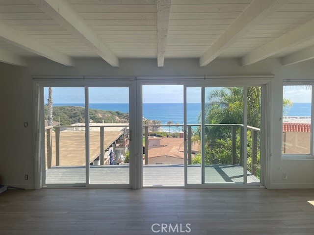 White Water Views- Epic Beach Penthouse- Incredible unit has been completely remodeled. Enjoy ocean views while watching the dolphins and beachgoers play in the surf from your brand new viewing deck. Double glass sliding doors allow natural light and cool ocean breezes to fill the room. This unit is located in a well maintained six unit Mid Century apartment building in the desirable neighborhood called "The Loop". The building is just 300 yards the from the beach and beach trail. The city put in a short cut walk way two buildings down, taking you to the bluff top grassy park area and steps that lead you to the sea. This open floorpan gives you plenty of room to make it your special zen retreat and feels as if your on top of the world. Part of its charm is the wood beam ceiling through out the entire space. Stunning luxury plank through out the unit. Kitchen features new stainless gas range and dishwasher. Microwave and Refriderator are included. New stainless sink and faucet. Freshly painted cabinets and new self closing drawers. Both bathrooms feature solid wood vanities with stone countertops. Both bedrooms and secondary bedrooms have new glass panel closet doors. Comes with one covered parking space in covered open garage area and storage cabinet. Shared laundry room features two sets of commercial grade machines. Ask owner regarding laundry fee per month. There is a community gas bbq and seating area along with bike rack and outdoor shower to rinse sandy feet.