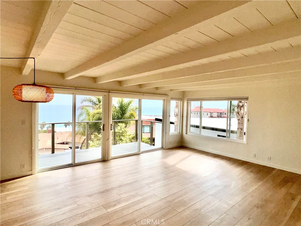 White Water Views- Epic Beach Penthouse- Incredible unit has been completely remodeled. Enjoy ocean views while watching the dolphins and beachgoers play in the surf from your brand new viewing deck. Double glass sliding doors allow natural light and cool ocean breezes to fill the room. This unit is located in a well maintained six unit Mid Century apartment building in the desirable neighborhood called "The Loop". The building is just 300 yards the from the beach and beach trail. The city put in a short cut walk way two buildings down, taking you to the bluff top grassy park area and steps that lead you to the sea. This open floorpan gives you plenty of room to make it your special zen retreat and feels as if your on top of the world. Part of its charm is the wood beam ceiling through out the entire space. Stunning luxury plank through out the unit. Kitchen features new stainless gas range and dishwasher. Microwave and Refriderator are included. New stainless sink and faucet. Freshly painted cabinets and new self closing drawers. Both bathrooms feature solid wood vanities with stone countertops. Both bedrooms and secondary bedrooms have new glass panel closet doors. Comes with one covered parking space in covered open garage area and storage cabinet. Shared laundry room features two sets of commercial grade machines. Ask owner regarding laundry fee per month. There is a community gas bbq and seating area along with bike rack and outdoor shower to rinse sandy feet.