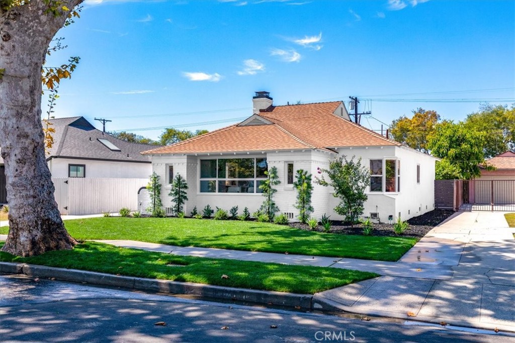 A stunning revitalized cottage nestled in one of L.A.’s most desirable neighborhoods. This fully upgraded residence blends architectural sophistication with high-end design, featuring expansive upgraded windows, and white cabinetry paired with quartz countertops and luxury light fixtures that radiate style and comfort. Step into the open-concept living space, bathed in natural light from oversized windows, and move effortlessly through the thoughtfully designed floor plan. The primary suite is a true retreat, complete with a walk-in closet, full spa-inspired bathroom, standalone soaking tub, and a spacious shower. Sliding doors open to a large lush backyard framed by mature trees , offering privacy and tranquility. A long driveway leads to the two car garage offering extra off street parking. This home also has a new HVAC system, a new electrical panel, new water heater, and new roof. Located just minutes from USC, K-Town, and Culver City, this one-of-a-kind property places you at the center of it all—culture, convenience, and community.