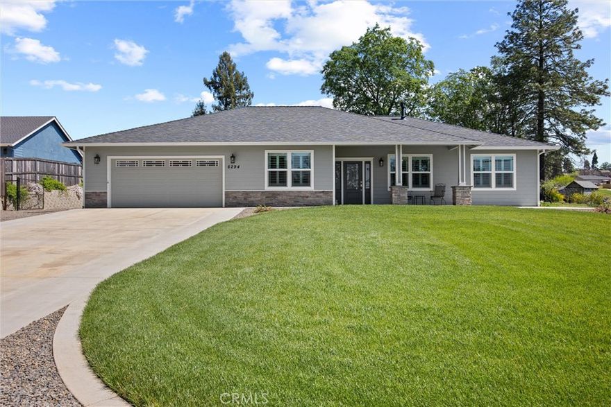 This like new home is situated near Billie Park, offering views of Butte Creek Canyon. It features an open split floor plan, a den, and a formal dining area. The kitchen boasts quartz countertops, an island, and stainless steel appliances. The 3 bedrooms and the den are carpeted, while the rest of the home has wood plank flooring. Ceiling fans with remote and switch controls are in all bedrooms. Professionally installed Graber composite shutters with a split top/bottom design enhance the bedrooms and living area. The primary bathroom includes a large walk-in closet, a walk-in shower, a tub, and an additional linen closet. The guest bathroom features a tub/shower with a sliding glass door and extra counter space. 
An efficient 4-ton Rudd HVAC system easily cools and heats the entire house.
  
The newly installed, large 24-panel, 9.6KW OWNED solar system is mounted on a 44' x 19' engineered standalone steel patio cover, which includes two fans and multiple electrical outlets, creating a spacious outdoor living area. This solar system features the latest Tesla Powerwall 3 home battery, supplying power at night instead of relying on the grid, with live system operation viewable on the Tesla app. A Generac 18KW generator ensures continuous power when the grid, solar, or battery are non-operational. 
The garage door opener comes with two standard remote controls and can also be accessed remotely via an app, allowing for viewing inside the garage and opening or closing the door while away.
The well-maintained landscape includes an additional 2,000 sq. ft. of concrete, along with front and back Hunter sprinklers and drip systems. Grass areas are bordered by 10" concrete curbs, with plants in the corners and along the North and South boundaries. The large, covered back patio and landscaped backyard are separated from the RV parking/shed area by a decorative steel post and webbing redwood fence. The North side driveway leads to the RV parking/shed area, which features an 18' x 20' steel shed with a concrete floor and entrance ramp to the 8' x 7' roll-up door, as well as a 12' x 20' steel carport. 
Concrete block retaining walls sit on a concrete base along the North and South property boundaries. 
Wood fencing has been added across the far East border, and the existing wood fence has been reinforced with galvanized steel posts 
An improvement list is attached to the listing for agent access