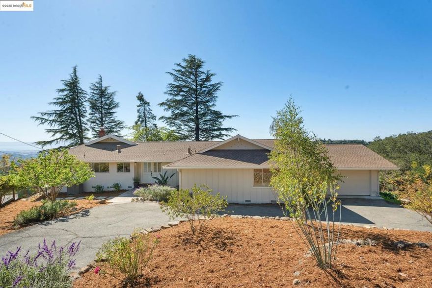 Irresistible ranchette with spellbinding vistas. Nestled among an outcropping of boulders, this gently sloped 1.6 acre parcel hosts an array of fruit trees, veggie beds, and housing for chickens. The all-level three-bedroom, two-bathroom layout takes advantage of the views and light. Living, dining and family rooms all open to the patio and rambling backyard. Vaulted ceiling and newly refinished wood floors. The sunny kitchen has quartz counters  and a large laundry room adjacent. The garage hosts a 50-amp outlet for a car plug. Newer roof, seismic update, and other bonuses. Head up the street to connect to Anthony Chabot Park or Leona Open Space. Ideal for hikers, cyclists, equestrians and nature lovers. OPEN SUNDAY, OCTOBER 12, FROM 2:00-4:30PM. Views:  Ridge