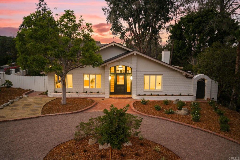 Tucked away on a serene .67-acre lot framed by mature trees, custom landscaping, and wide-open views, this just-completed renovation is truly one-of-a-kind. From the moment you arrive, you’ll feel transported—this property is equal parts country charm and resort-style escape, all within minutes of top schools, shopping, and the beach. The main home lives like a dream with 3 ensuite bedrooms all on the first level. A loft hang space (perfect as a playroom, lounge, or easily a 4th bedroom) with its own bathroom, as well as an office, are upstairs. The open-concept kitchen and great room are the heart of the home, featuring double islands, Calacatta Montreal quartzite counters, high-end paneled Thermador appliances, walk-in pantry with Pinky’s iron door, and a wood-burning fireplace under beamed ceilings. The primary suite is a sanctuary, complete with French doors leading to the backyard fire pit, a spacious walk-in closet, and a spa-like bathroom. Outside, the property shines with a resort-style pool featuring a waterslide, an additional plunge pool with a smaller slide, grass play areas, and multiple gathering spaces. The detached 3-car garage with stained-glass windows includes a full second level for storage or creative use, and the charming 1BR/1BA ADU with its own kitchen, entrance, and parking offers the perfect guest retreat, home office, or income opportunity. Renovated top-to-bottom with premium finishes, thoughtful design, and playful sophistication, this estate is equally suited for private living or unforgettable entertaining. Come experience the magic of Olivenhain living, where timeless charm meets modern luxury.