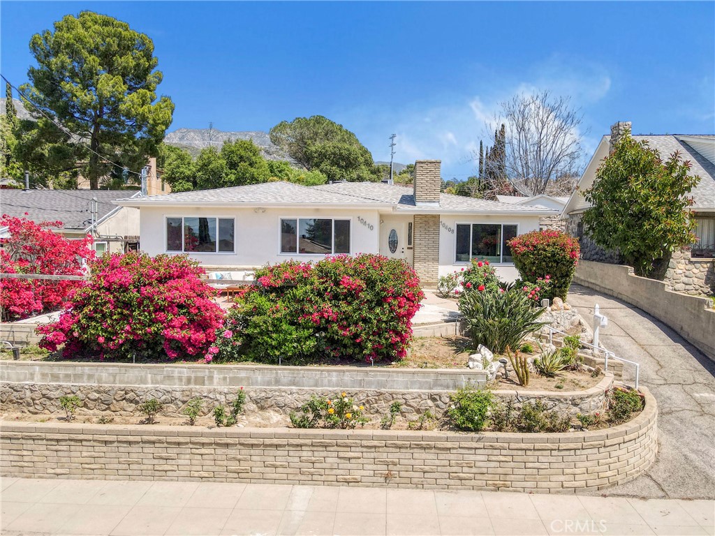 Beautifully Remodeled Tujunga Home! This stylishly updated 3 Bed, 2 Bath home in the heart of Tujunga features a bright open floor plan, refreshed bathrooms, and a welcoming living room with classic fireplace. The modern kitchen boasts white shaker cabinets, new appliances, and plenty of counter space. Enjoy brand new recessed lighting, new windows, a hardscaped front patio, and a new washer/dryer. Significant upgrades include a new roof, A/C unit with new ducting, attic insulation, copper plumbing, upgraded electrical, and ABS sewer lines—making this home truly move-in ready. A newly built 1 Bed, 1 Bath J-ADU may be available for an additional $2,400/month, ideal for extended family or rental income. Close to hiking trails, parks, local cafés, and Foothill Blvd shops, this home offers peaceful living with city convenience just minutes away!
