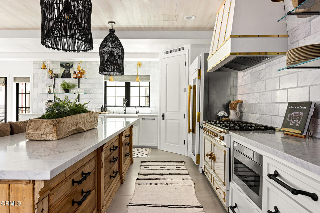 Great Value for a 2022 custom-built home at Pierpont Beach in Ventura!Now is your opportunity to celebrate life at the best beach in Ventura County. Built in 2022 this like-new coastal home is move-in ready, with over $200,000 in recent upgrades. Just bring your sunscreen.Bespoke Furnishings Included. Ideal for second home or relocation. Beautifully designed with a flexible floorplan perfect for a primary residence, tranquil beach retreat, or multi-generational nest, with plenty of space for entertaining guests. Bedrooms on all three floors with an elevator for easy access. The kitchen is eye candy, hosting top of the line appliances such as: La CornuFe, Fisher and Paykel, and True. Paired with a walk-in pantry, open shelving and plenty of drawer space, there is more than enough storage for all your culinary needs.The living spaces have upbeat finishes, loads of windows, wall mounted TV's and La Cantina style glass doors. Whole house sound system.Baths are well-equipped with curbless showers and two soaking tubs (one with a fireplace). Two laundry areas, with a third hookup available.You'll find interior and exterior custom automated blinds, several patios, and charming outdoor vignettes along with a low-maintenance private yard.Keyless entry gates, a motion activated security system and third floor ocean and mountain views round out just some of the many special details of this almost-new home.Additional Features:Fountains; Pre-wired for Driveway Gate; Wired for Electric Vehicle Charging Station; Full Size Wine Refrigerator; Laundry Connections on each floor; BBQ Grill. One block to ocean in charming Pierpont Lanes neighborhood. Easy access to L.A. or Santa Barbara Counties via 101. Close to Ventura Harbor, and historic Downtown Ventura.