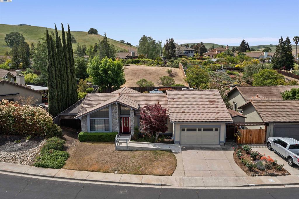 1116 Vista Point Lane is a single-story home perched in the quiet, friendly court with minimal traffic of tranquil Pine Hollow Estates in Concord, CA. Dreaming of adding your personal flair, this home’s open canvas is ready for your vision. Built in 1989, this 4 bedroom, 2.5 bathroom residence spans 1,898 sqft of accessible living on a generous 17,016 sqft lot. The open floor plan welcomes abundant natural light into each room, with wide hallways and ADA compliant features including a ramped entry and accessible bathrooms ensuring comfort for all ages and needs. Gather around the kitchen’s custom cabinetry, granite countertops, and modern appliances. The formal dining area flows into a warm entertainment room, complete with a brick fireplace perfect for cozy evenings or your festive gathering. The 4 generous bedrooms offer ample flexibility for family, work-from-home setups, or guest accommodations. Two full baths plus a powder room for convenience. The extra large fenced yard has room to possibly install a pool, add an ADU, or set up a pet/play zone. Enjoy year-round comfort with central air conditioning and forced-air heating. A 2-car attached garage, and a laundry room with appliances is onsite.