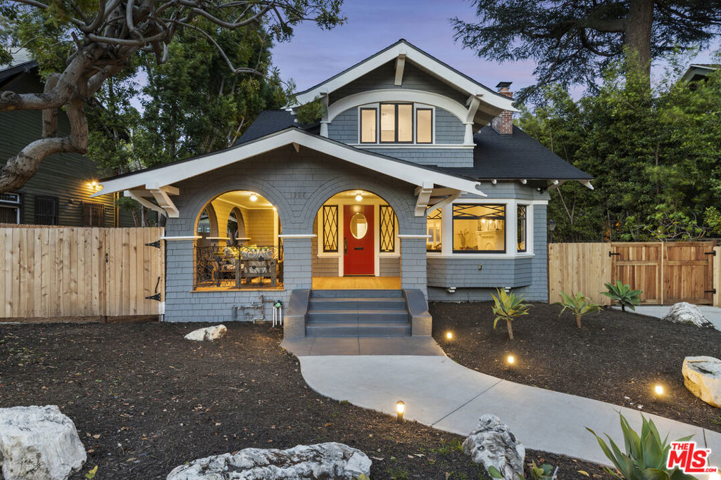 Located on a block renowned for its early 20th century bungalows on a gated expansive privately landscaped lot, this circa 1906 storybook charmer with pool is one of the linchpins of Hollywood Grove: Los Feliz' only Historical Preservation Zone. Newly restored and ready for its next chapter, this home has undergone a thoughtful and luxurious restoration, effortlessly retaining its distinctive vintage ambience while offering bright casual modern style. Meandering walkway leads to front entrance with huge extraordinary wrap around covered porch, with original shingled arches framing the picturesque street view. Old world vestibule opens to formal living room with gorgeous original fireplace, original wainscot, and copious original windows allowing natural sunlight and nature to completely envelop the entire space. Formal dining room with patio French door leads to the chic newly remodeled kitchen: with built-in banquette, new cabinets, new counters, new fixtures and brand-new chef's appliances all overlooking the back and side yards. Also downstairs is a huge third bedroom or family room with separate office alcove areaall opening to the back yard. Upstairs are two more bedrooms and two baths including a sublime primary suite with new tiled bath with separate shower and soaking tub plus separate office nook. The resort like back yard is a 10: a stunning sanctuary for relaxingand entertaining with huge lagoon-style swimming pool, dramatic waterfall, and cozy gazebo. Long driveway and detached two car garage for parking or hanging out. Highlights include original: hardwood floors, moldings, doors, windows and exterior wooden shingles plus new plumbing, electrical and roof. Amazing area walkable to Franklin Village, Oaks Gourmet, Gelson's, Lazy acres and Griffith Park. Superb!