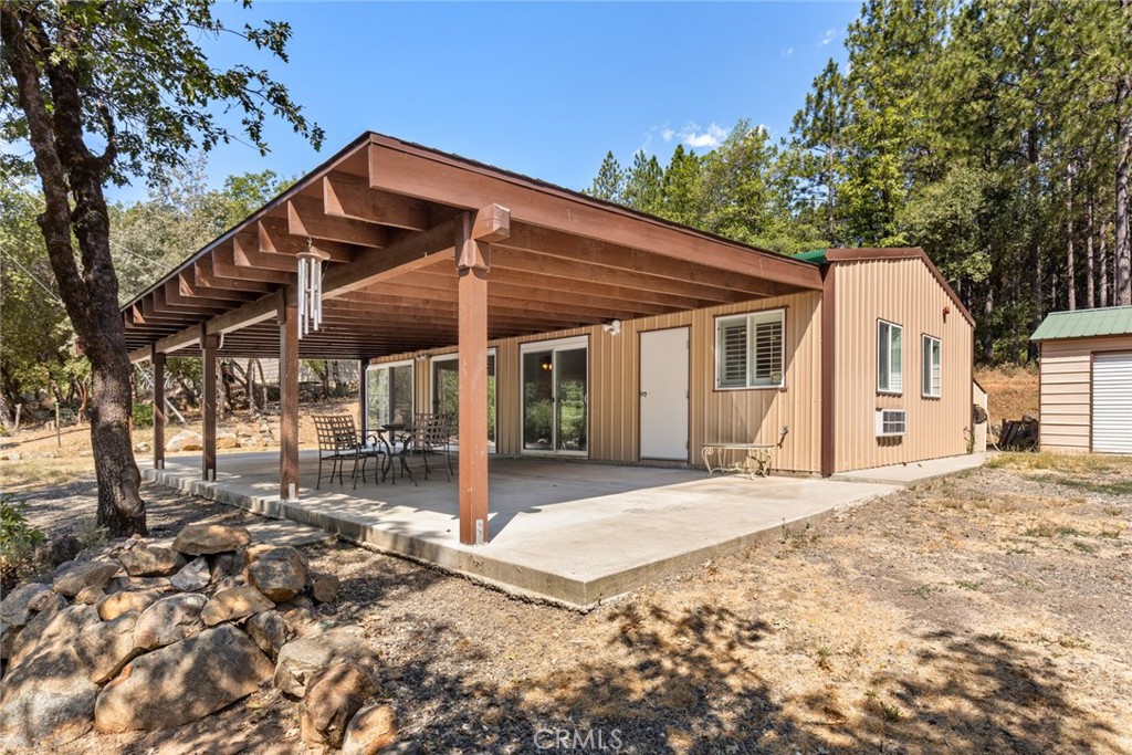 Tucked away in the peaceful foothills just outside Oroville, this 20.42-acre estate offers comfort, outdoor living, and privacy.  Step inside and you’ll find laminate flooring, custom cabinetry, and all matching appliances that make the kitchen as functional as it is beautiful. Recessed lighting and energy-efficient windows fill the home with warmth and light, while a ductless mini-split system, wall unit, and wood stove ensure you stay perfectly comfortable throughout every season.  The massive covered patio creates an ideal setting for entertaining, quiet evenings, or simply enjoying the outdoors.  For those who need space and a garage, here it is. The property features three expansive metal shops, perfect for car enthusiasts, creative projects, or storing equipment. With two separate parcels totaling over 20 acres, this property has endless opportunities.