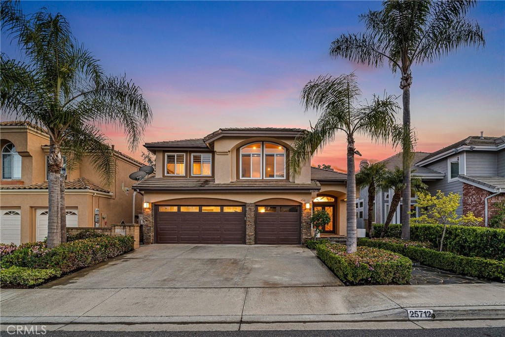 Showcasing unmatched luxury and sweeping bluff top views is this gorgeous residence which is situated at the heart of a quiet neighborhood cul-de-sac in the highly sought after hilltop enclave of Moulton Ranch in Laguna Hills. This is the one! With high-end finishes throughout, a downstairs ensuite bedroom, a custom hardscape view yard and a truly enviable floor plan don’t miss this chance. Starting with great curb appeal, including the custom stonework hardscape, mature planting beds and a grassy lawn enter through stunning custom French doors into a soaring vaulted ceilings foyer and formal living room. With great light from large yard view windows, a focal point fireplace – the first of three in the home – and ample space to spready out the formal living room is open to the formal dining room with large patio view windows which flood these formal spaces with a wealth of afternoon natural light. Off of the dining room is the chef’s kitchen which has upgraded cabinetry, top-tier stainless steel appliances, a central island with possible bar seating and a dedicated task sink and a bar peninsula that extends all the way to an adjoining dry bar with stacked wine refrigerators. The kitchen also features a sizeable casual eat in area and view windows out to the patio. Sharing the great room vibe is an oversized family room which has an abundance of space, the second hearth, and is open to the dry bar making this the perfect place to entertain. With French doors out to the patio deck this space offers true indoor/outdoor living. A downstairs ensuite bedroom with step in shower, a guest half bath and an inside laundry room completes the lower level. Upstairs is a large second family room space and 3 additional bedrooms that start with the spacious primary suite which has a stunning spa like ensuite with a custom dolphin shower enclosure, granite counters, a privacy water closet door, a walk in closet and great light. A cozy third fireplace and a private panoramic view deck complete this must-see primary retreat. Two additional bedrooms and an updated guest bath complete the upper level. Featuring an attached 3 car garage, a 3 car driveway, and countless upgrades, make sure you see this home! Minutes from a local neighborhood park, great schools, shopping, dining and commuting options, the beach and everything South County has to offer don’t miss this opportunity!