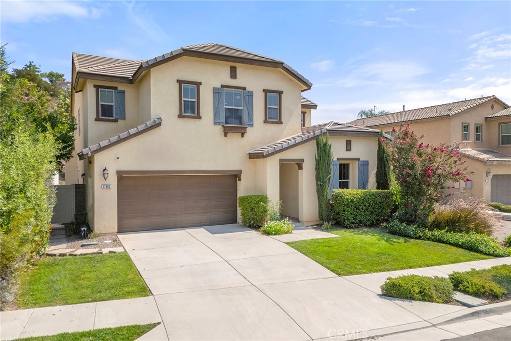 SPECTACULAR, SHOWS LIKE A MODEL HOME with beautifully added upgrades, to this stunning 5-bedroom, 4-bathroom home nestled in the highly desirable Sycamore Creek/Kite Ridge community and offers incredible curb appeal with lush landscaping and serene foothill views. Featuring a spacious and open floorplan, the home showcases gorgeous luxury vinyl plank flooring, recessed lighting, a custom neutral paint scheme, and thoughtful upgrades throughout. The chef’s kitchen is a showstopper, boasting rich wood cabinetry, granite countertops, a huge center island with bar seating, trendy pendant lighting, walk in pantry, and an open concept that flows into the inviting family room with fireplace and full-wall sliding glass doors leading to a covered California room—perfect for indoor-outdoor living. A custom bar area adds to the entertaining appeal with upper glass-front cabinets, wine storage, a built-in beverage fridge, and a dedicated Home Planning Center with built-in desk and cabinetry. One spacious bedroom with private ensuite is conveniently located on the main floor with beautiful wall to wall custom built-ins, while four additional bedrooms are upstairs including a secondary bedroom with custom built-ins and a loft ideal for a home office or bonus space. The luxurious primary suite offers hillside views and a large ensuite bath with dual vanities, a soaking tub, separate walk-in shower, and walk-in closet. Throughout the home, top-down/bottom-up shades offer both privacy and natural light. Outside, the professionally designed backyard is an entertainer’s dream with a brick pergola featuring a built-in BBQ grill, refrigerator, side burner, gas fire pit, low-maintenance yard, and no rear neighbors backing to the tranquil Nature Preserve. Energy-efficient touches include a tankless water heater and smart sprinkler systems in both front and rear yards. Tandem 3 CAR GARAGE. Residents of Sycamore Creek enjoy resort-style amenities including parks, scenic walking trails, swimming pools, clubhouse, gym, and nearby Deleo Regional Park with tennis, basketball, skate park, dog park, and more. Close to schools, shopping, dining, and major commuter routes—this home truly has it all!
