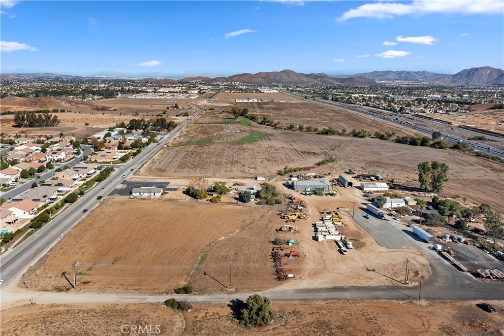 ***COMMERCIAL LOT on 8.61 ACRES in MENIFEE*** This property is Flat Usable Commercial mixed use land with over 400 feet of frontage on Haun Road and 600 feet of frontage on Garbani Road. This is one of the BEST available Commercial Lots in the area and is located adjacent to the 215 Freeway and very visible from the Freeway. Future Freeway access makes this a prime lot with so many possibilities. There is a massive 6500 Sq. Ft. Steel Building/Workshop, two additional Large Steel Buildings and other Outbuildings with living quarters. The property is zoned as EDC-CC (Supplements attached).