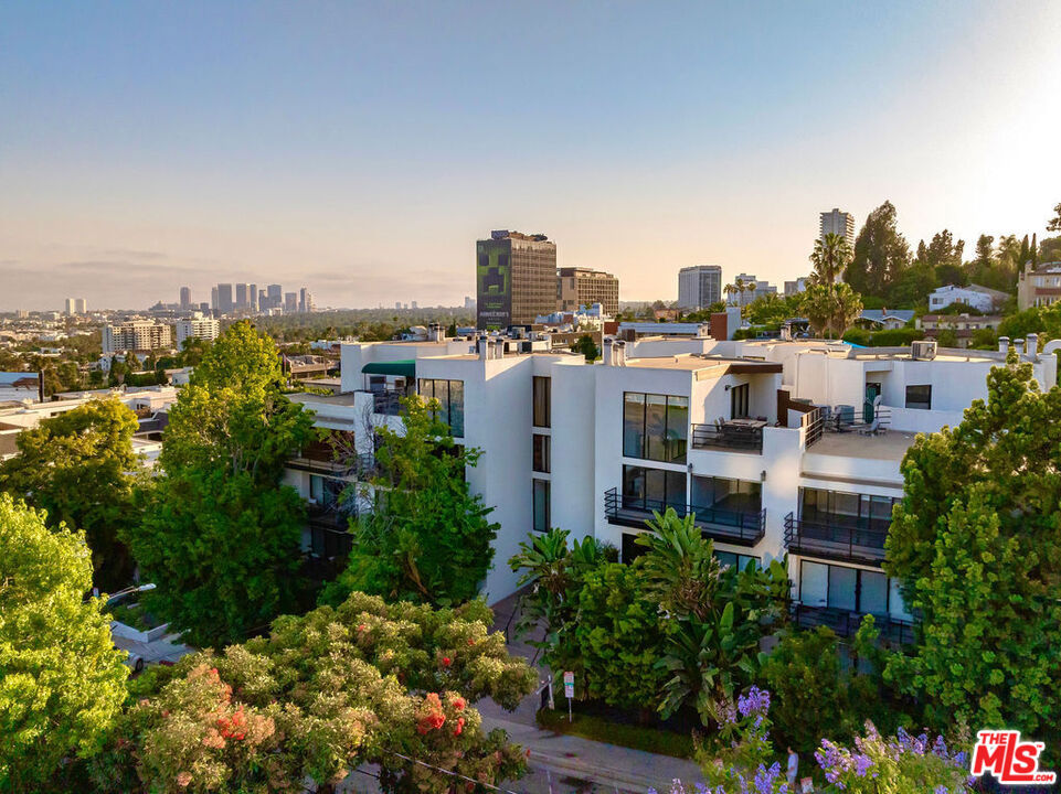 Your contemporary oasis awaits on a quiet street just above the iconic Sunset Strip and vibrant Sunset Plaza now reintroduced at an improved price with fresh cosmetic updates to make it shine! This spacious 2 bed, 2 bath condo offers 1,432 sq ft of modern living at Vista Larrabee, complete with real hardwood floors, updated lighting, and an expansive private patio that spans the entire length of the unit with direct access from every room - a true indoor-outdoor vibe perfect for entertaining or relaxing. Inside, you'll find an open-concept layout with a chef's kitchen featuring: Caesarstone counters, stainless steel appliances (double-door fridge, wine fridge, stove, microwave, dishwasher), breakfast nook, pantry, and wet bar. Host dinner parties in the spacious dining area, then unwind in the airy living room with modern fireplace. The generous primary suite has multiple closets (including a walk-in) and a masterfully renovated ensuite bath with dual vanity, stylish tilework, and a grand shower. The second bedroom also opens to the patio and sits across from an updated hall bath and in-unit laundry closet. Building amenities include a rooftop deck with panoramic views, BBQ and lounge seating, a sauna, and an outdoor gym with updated equipment. Two secure side-by-side parking spaces with storage and HOA dues covering water, trash, sewer, and earthquake insurance complete the package. Unbeatable location near Equinox, SoHo House, Viper Room, EV charging, and all the best restaurants and nightlife in West Hollywood. Welcome home to your very own Sunset Plaza respite!
