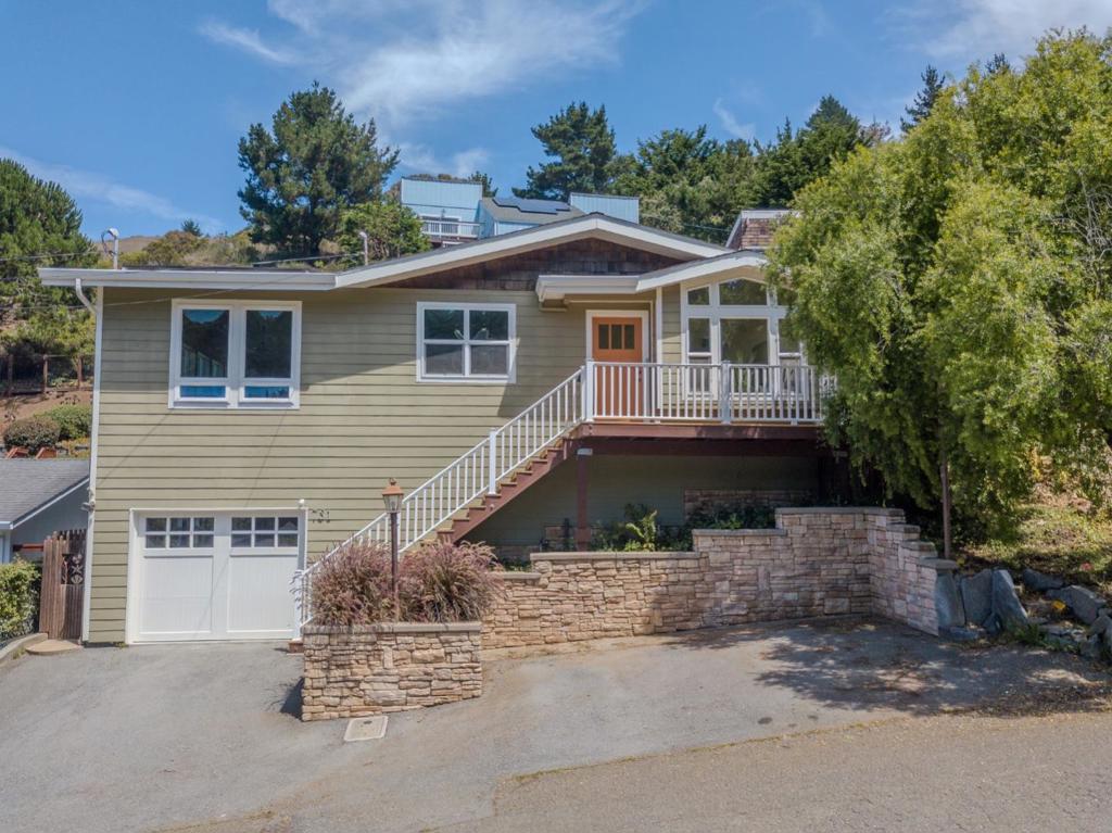 Welcome to 731 Rockaway Beach Ave, a light-filled Pacifica home designed for comfort and coastal living. Vaulted ceilings, large windows, skylights, and bamboo flooring create a bright and airy atmosphere throughout. From inside, enjoy partial ocean views and a layout that seamlessly blends indoor and outdoor living. The beautifully landscaped backyard is a private sanctuary filled with flowering plants, mature trees, and lush greenery. A separate office space off the garage offers flexibility for work or creative pursuits, while abundant storage provides everyday convenience. Modern upgrades include owned solar and a 240V EV charger, bringing sustainability and efficiency into your daily routine. The inviting kitchen and living areas are perfect for gathering, while the tranquil setting makes it easy to unwind. Located just minutes from beaches, hiking trails, shops, and dining, this home combines natural beauty with modern amenities in a truly special coastal retreat.