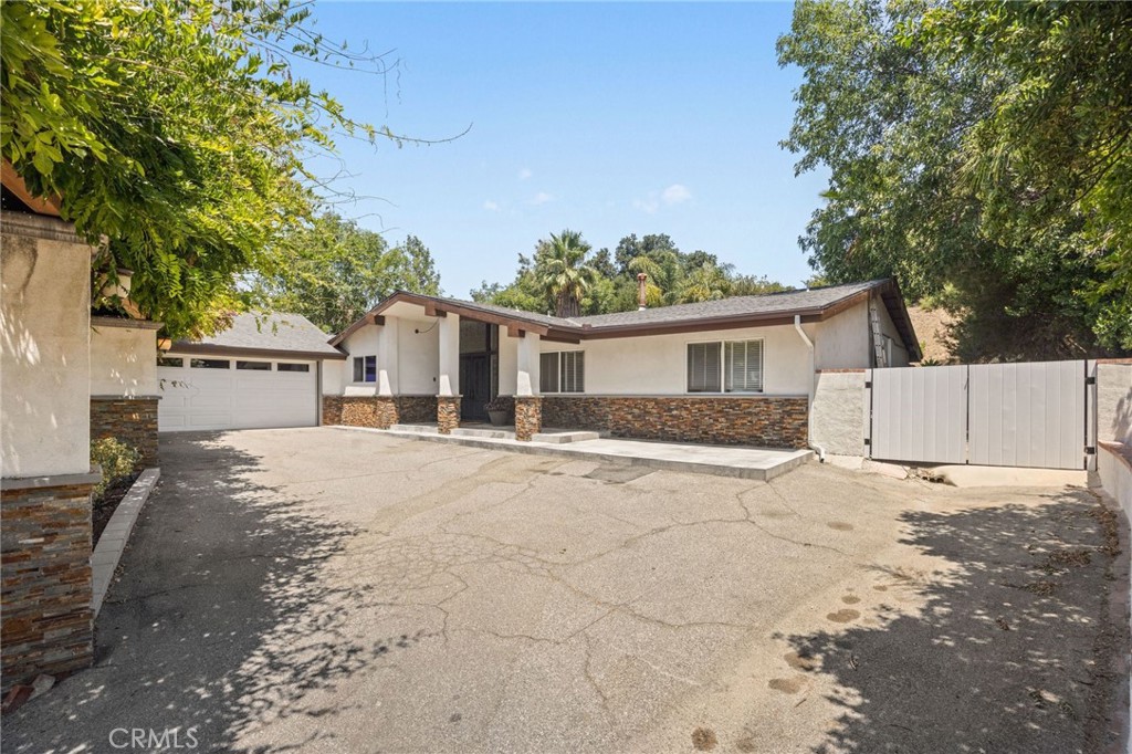 Beautiful remodeled single story home North of Rinaldi in Granada Hills! Open floor plan, Chefs Kitchen, custom cabinets with roll out shelves, self-closing drawers and device charging drawer. Built in Hutch/Bar with Wine refrigerator, Quartz counter tops, Carrera Marble back splash, Built-in Sound system. LED recessed lights, stainless steel appliances. Real European Oak Floors. Designer powder room, Leaded Stain Glass Entry, Dining room, Living room. Primary Bedroom boasts a remodeled en- suite bath with custom vanity and deep built in recessed cabinets. Two more bedrooms and a Full Hall bath. In a separate wing there is a 4th bedroom and bath and large bonus room with separate entrance, perfect for an ADU. Private and serene back yard with covered patio, lush planters and BBQ Area. Large side yard with double gate. Perfect for a boat or RV. Located in the award-winning school district of Granada Hills Charter High School.
