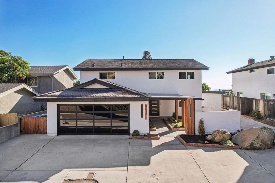 Fully Remodeled Modern Home with ADU & Sweeping Views Offered at $1,699,000 - $1,750,000. This completely remodeled Del Cerro showpiece checks every box for modern living. From the moment you arrive, its striking curb appeal, clean architectural lines, and updated landscaping set the tone for what’s inside—an entirely turnkey home thoughtfully redesigned with today’s lifestyle in mind. Enter to a bright, open-concept interior featuring luxury finishes throughout, including a stunning entertainer’s kitchen with a marble waterfall island, designer cabinetry, and premium appliances. The dining room is anchored by a bold electric fireplace inviting you to the gorgeous living room where sliding doors lead to the backyard oasis—complete with a resurfaced pool, large covered patio, and expansive west-facing views perfect for sunset entertaining. Upstairs, the oversized primary suite offers a spa-worthy retreat with a soaking tub, rainfall shower and dual vanities. A room downstairs provides flexibility for guests or a home office. One of this property’s most valuable features is the attached, private-entry ADU—fully equipped with its own kitchen, bathroom, and laundry hookups. Ideal for multi-generational living, long-term guests, or a strong income-producing rental, it adds unmatched versatility to this already incredible home. Additional highlights include solar, central AC, ample parking, and close proximity to SDSU, top-rated schools, shopping, dining, and freeway access. Modern, functional, and fully move-in ready—this is Del Cerro living at its finest.