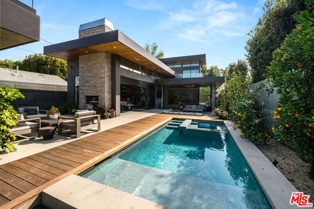 This stunning Venice estate masterfully combines the perfect balance of modern luxury, comfort and privacy. Built in 2016, this spacious home was designed for seamless indoor-outdoor living, featuring high ceilings, expansive windows, and floor-to-ceiling sliding glass doors that welcome the exterior spaces and fill the home with natural light. Elegant finishes, including concrete and oak flooring, plastered walls, and custom cabinetry, add to the sophisticated ambiance. The primary suite is a private retreat with a walk-in closet, a lavish bathroom, and its own private deck. Outside, enjoy California living at its finest with a heated in-ground pool and spa, a fire pit, and a barbecue area, perfect for relaxation and entertaining. There are three additional generously-sized bedrooms, each with their own en-suite bathroom. The home also features a two-car detached garage and modern security features. A guesthouse with its own bath and private deck above the garage offers additional space for living, work, or leisure. Situated in the vibrant Venice neighborhood, close to dining, attractions, and entertainment, this home is ultimate blend of indulgence and convenience.