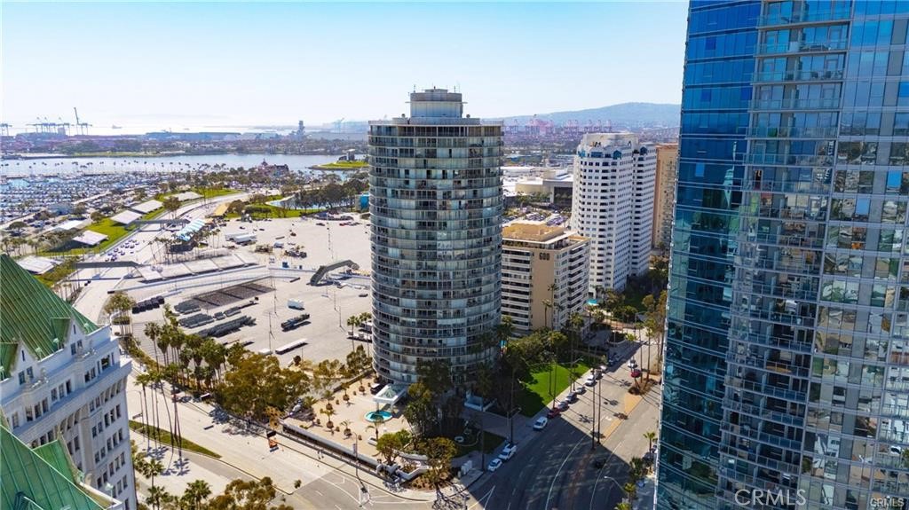 Experience a high-rise coastal living in this stunning 2 bedrooms 2 bath condo on the 26th floor of the iconic International Towers. Enjoy the breathtaking city light views and peek-a-boo ocean view from floor to ceiling windows and a spacious wrap-around balcony. This newly renovated unit features light toned engineered vinyl plank flooring in the main living area, new carpet in the bedroom. The well appointed kitchen features Quartz countertops, and stainless steel appliances. Laundry area with stackable washer dryer. Both bedrooms offer direct balcony access with breathtaking views! The mid century modern building offers resort style amenities: 24/7 concierge and security , secure gated parking , pool, world class gym, business center, lounge areas, outdoor BBQs and fire pits, recreation/party room. Prime downtown Long Beach location. Explore a vibrant lifestyle with the ease of walking to the nearby beaches, parks, restaurants, boutique shops, Shoreline Village, the Pike Outlets, The Queen Mary , the world class Aquarium of the Pacific and the Pine Avenue dining and nitelife.