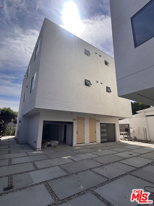 Move In Special: One Month Free! Welcome to 1228 S Berendo Street! Be the first to live in this newly constructed, stylish 4 bed + 3 bath townhouse-style unit, centrally located in the vibrant Mid-Wilshire neighborhood. Two beautifully designed units are available: 1230 and 1230 1/2. Step inside to find gorgeous hardwood floors throughout and a sun lit main level with a bright, open-concept layout. The modern kitchen comes fully equipped with stainless steel appliances, including a refrigerator, stove, and over-the-range microwave. Ample cabinetry and a sleek kitchen island offer plenty of prep and storage space perfect for entertaining or daily living. The kitchen seamlessly flows into the spacious dining and living area, which features a private balcony for relaxing or enjoying your morning coffee. A full bathroom and one bedroom are also conveniently located on the main floor. Upstairs, you'll find three additional bedrooms and two full bathrooms. Top it all off with a private rooftop deck, the perfect space for outdoor dining, relaxing, or taking in city views. The ground level features a private 2-car garage and a private fenced back yard. For added convenience, there are washer & dryer hookups and central AC & heating in each unit. Moments away are popular restaurants, trendy cafes, & markets. (Move in special: one month free rent is prorated over a 12-month lease, base rent is $4,600. More pictures will be uploaded soon.)