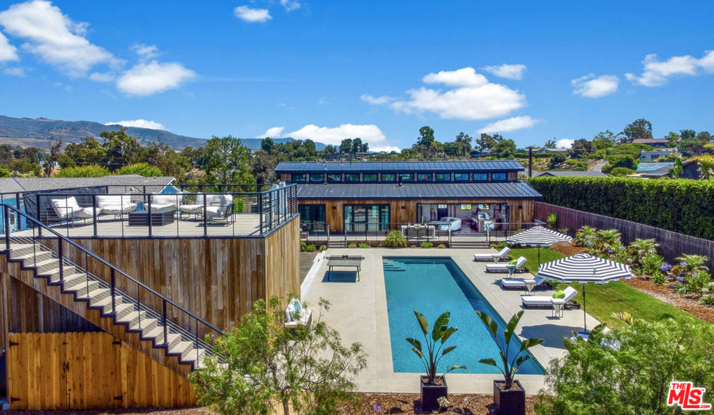 GOOD TIMES & TAN LINES! BRAND NEW Three bedroom modern farmhouse with a spacious two bedroom guest home in the prestigious and sought-after neighborhood of Point Dume! This unique and impressive property designed by architect Quentin Stanton is an entertainer's delight. Set on just over one acre with breathtaking mountain and partial ocean views! Behind the private gates you will find a peaceful and tranquil setting where you can enjoy the heartwarming sunrises and sunsets. Upon entering the primary home, you will be greeted by a bright and airy space that leads to an open floor plan, laden with luxurious finishes, soaring high ceilings with wood beams, wide plank hardwood flooring, and seamless indoor-outdoor living space. A sleek and refined living room with a gourmet kitchen and folding patio doors that lead you to an expansive deck area overlooking a majestic lap pool and joy-inspired garden. Adjacent to the pool is a large viewing deck offering unobstructed views of the area. A charming walkway below the viewing deck leads you to a private detached guest home on the lower portion of the property with another viewing deck that is surrounded by wildlife, flowers, and additional canyon views. The guest home has it's own private gated entry and private garden. This unique property would make a great vacation home. Grab a golf cart and take a ride down to Zuma beach, Big Dume/Cove Beach, or visit the nearby shops and restaurants at the Point Dume Village. Tons of usable/flat space. Garage can convert into game room, gym, or studio. Electric car charger in garage. A must see!
