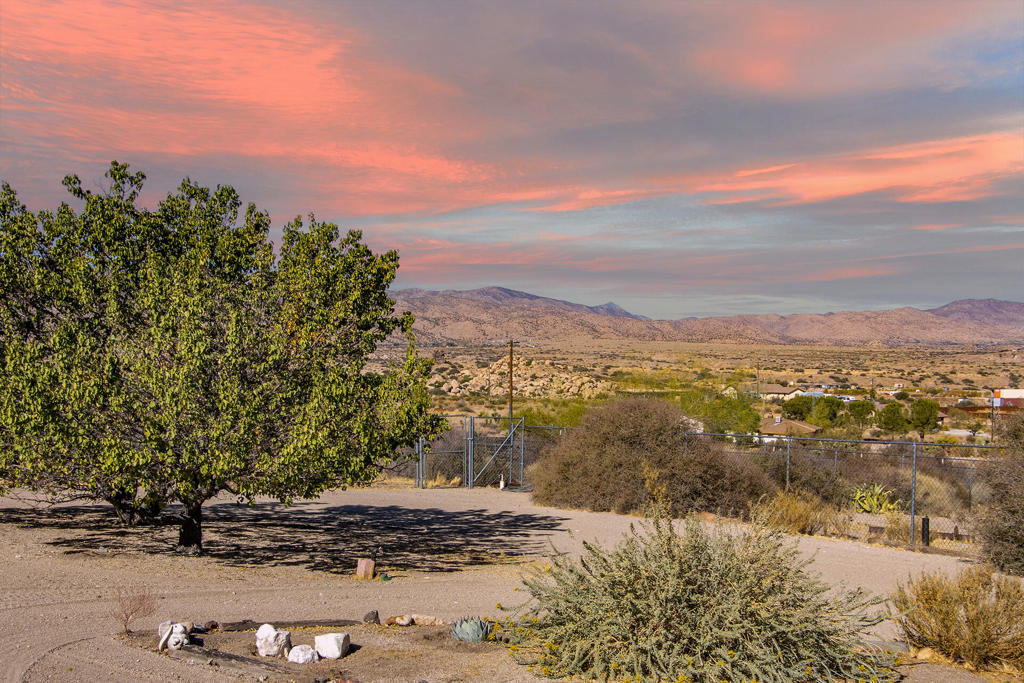Welcome to your serene desert retreat at 5626 Mountain View Lane, nestled in the heart of picturesque and world renowned Pioneertown - only 1 mile from Mane Street. This expansive property offers an unparalleled opportunity to experience the tranquility and natural beauty of desert living.Situated on an impressive 1.25 acres -fully fenced, flat and clean . This spacious lot provides ample space for privacy, outdoor activities, star gazing, horses, hobby farm. Enter to a massive Greatroom with wood burning fireplace as the center piece. Light and bright with ample space for living, dining and entertaining. Beautiful kitchen with breakfast bar with custom acacia wood countertop. Island with oversized gas range, built in oven, microwave, dishwasher, stainless fridge, stone counters and upgraded cabinetry. Primary Suite with spa like bath including stone shower and deep oversized separate jet tub . dual sink granite counter vanity and walk in closet. Two Bedrooms and impressive remodeled bath on the opposite end of the home . Interior laundry/mud room located off the double attached garage. Outdoor living space consists of covered front porch, rear covered cozy patio and a 3rd oversized patio with breathtaking views of the Pioneertown Mountain Preserve and Sand to Snow National Monument.Property also has a large slab area (slab of former residence- ready for your guest home, art studio, yoga studio?50 amp RV with Hook ups- perfect for your out of town travelers or for storing your own toys!Other interior features include a tankless water heater, recently inspected fire sprinklers ,high efficiency HVAC system and septic was recently inspected.The property boasts a harmonious blend of rustic charm and modern comfort, perfect for those seeking a peaceful escape. Whether you're drawn to the area's renowned outdoor recreation or simply want a quiet place to relax and enjoy the stunning vistas, this home offers it all.Don't miss this unique opportunity to own a slice of desert paradise in Pioneertown, where you can experience the magic of the high desert while enjoying easy access to local amenities and attractions.Embrace the serenity and make 5626 Mountain View Lane your personal haven today. Contact us for more information or to schedule a viewing.