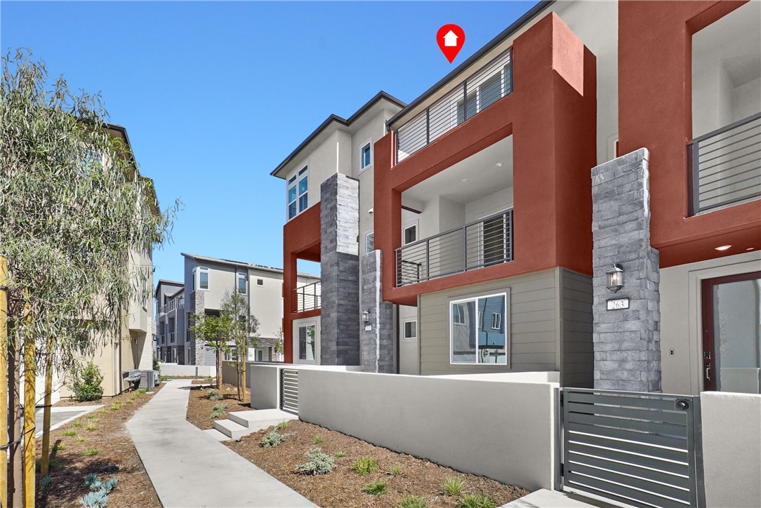 This luxurious 3-bedroom, 3.5-bathroom home in the prestigious Great Park neighborhood embodies the pinnacle of resort-style living. It boasts a fully paid-off solar system for eco-friendly and cost-efficient energy usage. Conveniently located, the home is just a short walk from Solis K-8 School and Portola High School.
On the first floor, there's a guest suite perfect for visitors or as a secluded escape. The bright and airy second-floor features an open-plan kitchen and living area, ideal for entertaining. The kitchen is outfitted with quartz countertops, premium appliances, and an expansive island, sure to please culinary aficionados. A balcony off the living area offers a serene spot to enjoy morning coffee. The third-floor primary suite also includes a private balcony, offering a quiet outdoor haven.