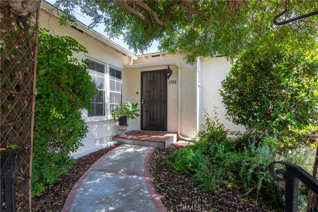 Welcome to this charming single-story home tucked away in the desirable Bixby Knolls neighborhood—where tree-lined streets and a true sense of community await you. As you step inside, you’re greeted by a spacious yet cozy living room, complete with gleaming hardwood floors, recessed lighting, a classic fireplace, and a large picture window that lets the sunshine pour in. This space feels like home the moment you walk through the door. The beautifully remodeled kitchen is ready for you, featuring BRAND NEW appliances and feel that flows into both the casual eating area and the more formal dining room—perfect for family dinners or entertaining friends. Toward the front of the home, two bedrooms share an upgraded bathroom with dual sinks, a shower-over-tub combo, and potential for a bonus storage area. On the other side of the house, you’ll find a second spacious living area along with two more bedrooms and a second 3/4 bathroom—ideal for a home office, guest rooms, or multigenerational living.
Step out to the backyard and you’ll find a lovely grassy area with plenty of room for gatherings, playtime, or quiet mornings with coffee in hand. The detached two-car garage offers lots of potential—whether you keep it as is or explore converting it into an ADU for guests, rental income, or a private retreat.