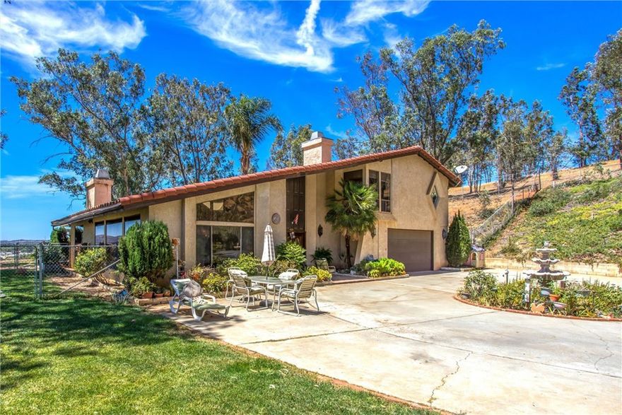 Custom-Built Hilltop Home with Panoramic Views of Banning. Perched on 1.24 acres with breathtaking, unobstructed views of the San Jacinto Mountains and San Gorgonio Pass too. This stunning custom home offers 4–5 bedrooms, 3 bathrooms, and 2,972 sq. ft. of versatile living space. Designed for comfort, style, and entertaining, this property is truly one of a kind. Step inside to a bright, open atrium that seamlessly connects the home’s spaces. The spacious living room features a cozy fireplace, while the beautifully upgraded kitchen boasts a newer stovetop, custom backsplash, and gorgeous granite countertops. The remodeled master bath serves as a spa-like retreat, complete with a large soaking tub and modern finishes. Additional features include: Flexible floor plan: 3 bedrooms and 2 bathrooms upstairs, plus 1 bedroom and bath downstairs. Bonus room upstairs is ideal for an office, craft room, or den. Large windows throughout the dining, living, and kitchen areas fill the home with natural light and showcase panoramic views. Back patio is perfect for entertaining or relaxing. Second garage/workshop has plenty of parking and storage, with potential to convert into a small ADU or workshop that already includes attached plumbing. Ample outdoor space. Circular driveway, private hilltop setting, and mature trees provide both privacy and charm. From sunrise to sunset, enjoy sweeping, unobstructed vistas from nearly every angle perfect for relaxing, entertaining, or simply soaking in the beauty of your surroundings. With space, style, and spectacular daytime and nighttime views, this home offers a rare opportunity to live in comfort and luxury in North Banning. Don’t miss your chance to own this exceptional property with space, style, and views that will take your breath away!