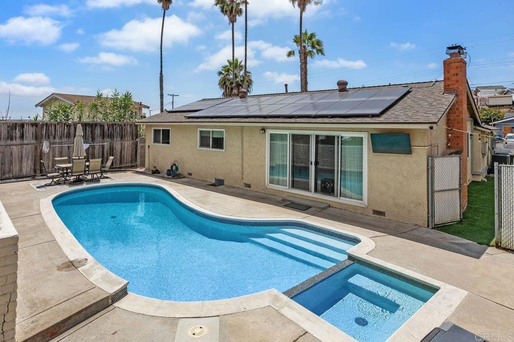 Welcome to your own private oasis in the heart of Chula Vista’s charming Halecrest neighborhood! This super cute 3-bed, 2-bath stunner may look unassuming from the curb, but step inside and prepare to be pleasantly surprised. This home is a total hidden gem, remodeled in 2019 and loaded with thoughtful upgrades that make everyday living feel like a staycation. Enjoy an open floor plan with beautiful laminate wood flooring, quartz countertops, a spacious kitchen island, and upgraded windows and doors that let the sunshine pour in. Chill out in total comfort with central AC and not one but two electrical solar systems to keep things efficient and easy on the wallet. The backyard is where the magic happens: a heated pool, a bubbly jacuzzi, a turfed dog run with citrus trees (lemonade, anyone?) and a custom engineered retaining wall that elevates your outdoor space literally. The upper terrace features a mini putting green and plenty of space to entertain, sunbathe, or sip cocktails under the stars. The finished 2-car garage is currently serving man cave realness, complete with laundry hookups and extra space to hang out but can easily be converted back for parking or storage if needed. Out front, you’ve got low-maintenance rock landscaping because who wants to mow the lawn when there’s a pool waiting? This is the home you didn’t know you were waiting for, but once you see it, you won’t want to leave.