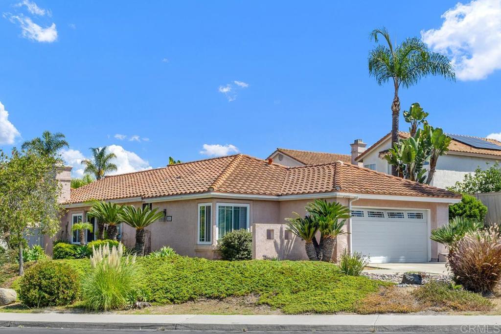 Charming Single Level Home on Expansive Lot! This inviting 3-bedroom, 2-bathroom home is located in the desirable Shadowridge community, nestled on a quiet, private street. The property sits on one of the largest lots in the neighborhood, providing ample outdoor space and privacy. With an extra-long driveway, there is plenty of room for additional home features a spacious living room that seamlessly flows into the dining area, both enhanced by vaulted ceilings for an open and airy feel. Beautiful vinyl flooring and dual pane windows add style and energy efficiency. All bedrooms are carpeted for comfort. The first room, currently used as an office due to built-in cabinets instead of a closet, is counted as a bedroom in tax records and has previously served as a bedroom. The master bedroom offers double doors for a touch of elegance. The layout is designed to be great for entertaining, with an abundance of natural light streaming throughout the home. On clear days, you can enjoy a peek of the ocean from the front yard or back bedroom, adding to the home's appeal. The private backyard is perfect for relaxing or entertaining guests, featuring a pergola and mature citrus trees. The landscaping is low maintenance, making it easy to enjoy the outdoor space year-round. While the home needs some TLC, it presents a wonderful opportunity to bring your imagination and create your dream home in a prime location.