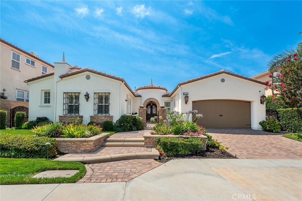 Rare Single-Story View Home in Guard-Gated Renaissance Community. Welcome to this exceptional 3665 sqft single-story residence located in the prestigious guard-gated community of Renaissance in Porter Ranch. Rarely available, this 4-bedroom, 4.5-bathroom home showcases stunning views, an open entertainer-friendly layout, and luxurious finishes throughout. Designed for both everyday comfort and elegant entertaining, the home features a formal dining room and a sleek wet bar perfect for hosting. The expansive gourmet chef’s kitchen is a standout, offering top-of-the-line appliances including a built-in Sub-Zero refrigerator, Thermador double oven, 6 burner Thermador stove top, custom cabinetry, under-counter cooling and warming drawers, and a large center island that flows seamlessly into the oversized family room with fireplace. The spacious primary suite serves as a true retreat, complete with its own fireplace, a spa-inspired en suite bath with two separate vanity sinks, a large spa tub, a glass-enclosed shower, and a generous walk-in closet. Additional highlights include plantation shutters throughout, plus a large laundry room with a utility sink, plenty of cabinet storage, and an extra dishwasher for added convenience. Step outside to enjoy indoor-outdoor living at its finest with a covered patio and Valley views—perfect for relaxing or entertaining. This rare single-story gem offers security, sophistication, and serenity in one of the most sought-after communities in the area.