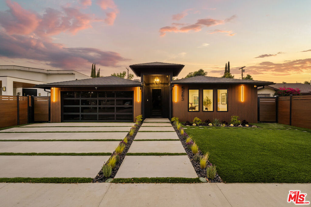 Stunningly reimagined with a refined eye for design, 5263 Buffalo Ave is a newly remodeled masterpiece that blends modern sophistication with timeless California living. Nestled on a quiet, tree-lined street, this home welcomes you with an expansive entryway bathed in natural light and framed by elegant olive trees, setting the tone for what's to come.Inside, wide-plank natural oak flooring leads you through an airy, open-concept floor plan designed for seamless indoor-outdoor living. At the heart of the home is a magazine-worthy chef's kitchen featuring an oversized island wrapped in natural stone, custom white oak cabinetry and shelving, Thermador appliances, and a hidden oversized walk-in pantry perfect for both entertaining and everyday life.The serene primary suite is a true retreat, complete with a cozy fireplace, custom walk-in closet, and a spa-like bathroom adorned with designer finishes. Additional bedrooms offer flexible space for family, guests, or a stylish home office.Step outside to a private backyard oasis, complete with a custom-built outdoor BBQ, mature landscaping, and multiple spaces to unwind or entertain under the sun. Thoughtfully equipped with solar panels, smart systems, and premium upgrades throughout, this home offers not only beauty but function and sustainability. Perfectly located just moments from Ventura Blvd's premier dining, shopping, and top-rated schools, this exceptional property is turnkey luxury at its finest.