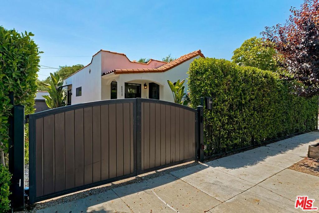 Hedged and gated for privacy, this charming Spanish home in West Hollywood features two bedrooms, two baths, and a den. It boasts an open floor plan with an updated kitchen, stainless steel appliances, and an island. The spacious primary suite includes a walk-in closet with a laundry area and opens out to a large entertainer's yard with a grassy area. The den or home office offers built-ins for your equipment. Highlights include newly refinished hardwood floors, central air and heat, a formal entry, a gated driveway with off-street parking for two cars, and a garage. Located conveniently close to Shopping, the boutiques on Melrose and Robertson, the Sunset Strip, West Hollywood Cafe culture & nightlife, and World-class eateries.
