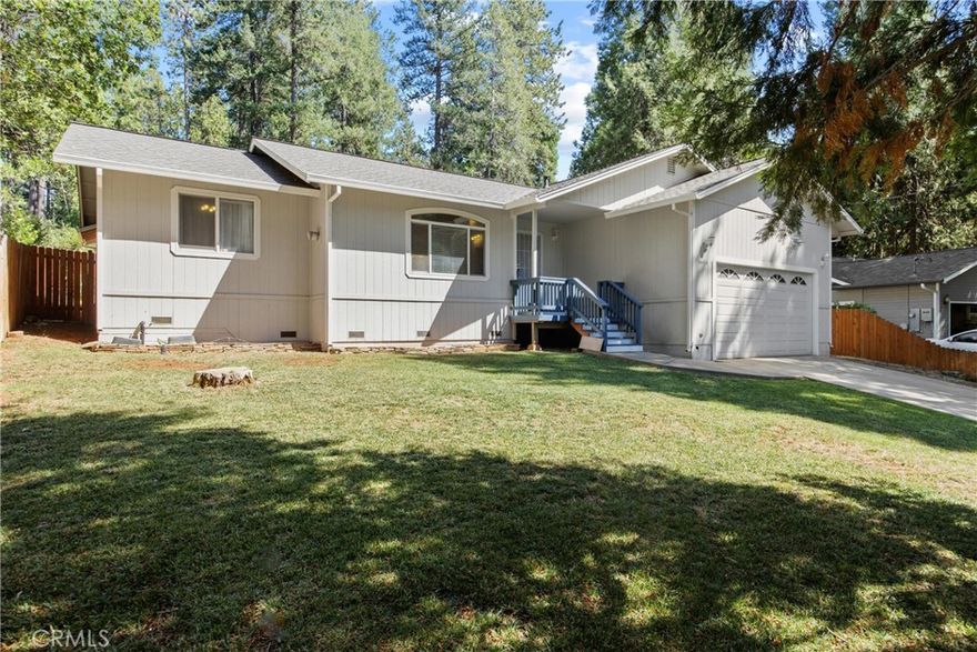 Welcome to this meticulously maintained home in the pines! With convenient access to Skyway, restaurants and groceries, this home features many upgrades you won’t want to miss. Through the front door you are greeted into the open living space that features a vaulted ceiling, a cozy propane fireplace, and a coat closet. The kitchen boasts cherry cabinetry, newer stainless steel appliances, tiled countertops and overlooks like the dining area with a large sliding glass door to the backyard. The split floor plan allows for a private primary suite, while the two additional guest rooms are at the other end, as well as the guest bathroom. The primary suite features a vaulted ceiling, walk-in closet and attached bathroom, with a dual sink vanity, tiled step-in shower, and jetted soaking tub. An additional bonus is the indoor laundry room complete with upper cabinets and a door to the 2 car garage. The garage provides ample storage space, including ceiling mounted storage rack, and is also fully insulated PLUS has its own ductless heating and air to allow for temperature control. Out back is the low-maintenance yard that is ideal for hosting gatherings with a large concrete patio, and a lawn with plenty of room to entertain. Never go without power, as there is a 22 kw GENERAC GENERATOR that powers the whole home in the event of a power outage. Additional features of this home include a whole house fan, NEWER (installed 2022) 50 year roof, dual pane windows, blinds throughout, a wired alarm system, as well as newer exterior paint (2022) and flooring throughout.