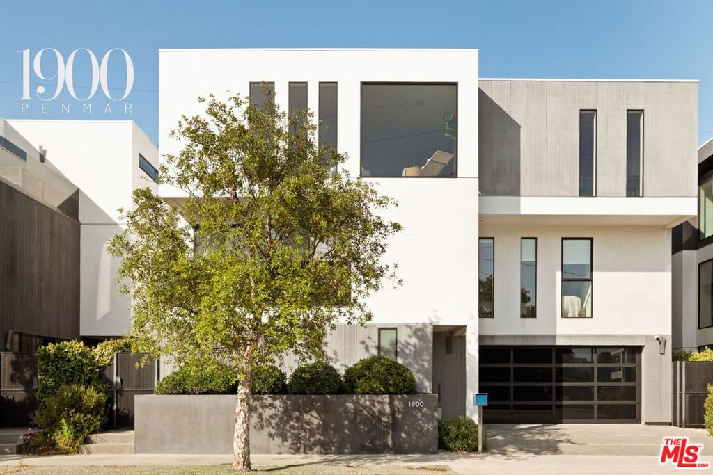 Experience the pinnacle of contemporary luxury in this newly built Venice Beach retreat, boasting an expansive 3,411 square foot layout capturing stunning panoramic views of treetops, mountains, and city lights through vast walls of windows. Sunlight cascades throughout every room, enhancing the home's sophisticated yet inviting ambiance. At the heart of the home lies an exquisite Italian kitchen, adorned with premium Fisher & Paykel appliances, elegant built in shelving, custom cabinetry, and a porcelain island that seamlessly transitions into a wraparound breakfast bar ideal for casual gatherings. Step through sliding glass doors onto the oversized private deck, a perfect setting for sunlit relaxation or stylish entertaining. 8.5" wide plank oak flooring gracefully unifies the spacious dining and living areas, highlighted by an inviting built in fireplace, creating an airy and open environment suited to both intimate gatherings and lively social events. The primary suite serves as a tranquil sanctuary, offering a generous balcony, a meticulously crafted Italian walk in closet, and a lavish bathroom featuring dual Italian vanities and a luxurious floating tub within a stunning porcelain clad shower. Two additional bedrooms provide exceptional comfort, each complemented by custom Italian millwork closets and private en suite baths. Versatile living spaces abound, including a 4th bedroom suite ideal as a private guest room, dedicated office, or home gym. The expansive family room opens effortlessly onto an outdoor patio, extending the living area and embracing indoor outdoor harmony. Modern amenities elevate your lifestyle with smart home automation featuring app controlled lighting, integrated Sonos sound system, five Lorex security cameras, DoorBird entry, alarm system, prewired solar, EV charger readiness, a rough in for an elevator if needed, and a spacious two car garage. Nestled just moments from the vibrant energy of Abbot Kinney, indulge in Venice Beach's premier dining, boutique shopping, and cultural hotspots, making this home an unparalleled blend of luxury, comfort, and iconic coastal living.