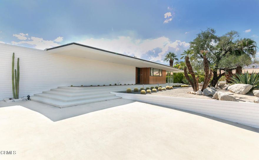 A true collector's item in the world of desert modernism, 73271 Buckboard Trail--known as the Paulette Herbert Johnson House--is a 1958 mid-century masterpiece by celebrated architect Walter S. White. Rarely does a home of this significance come to market--an exquisitely maintained and restored example of Palm Desert's architectural history, blending timeless design with resort-style living.Step through a pebble-stone entry into an open, light-filled floor plan where floor-to-ceiling glass walls, terrazzo floors, original wood paneling, and signature masonry walls create a seamless indoor/outdoor flow surrounding the living and dining areas. The custom wood panel kitchen cabinetry pays homage to its mid-century roots, while two beautifully appointed bedrooms feature cork-lined closets and bathrooms with authentic period tile and lighting. Natural light pours through every corner, framing breathtaking views of the surrounding gardens, mountains and desert skyline.The grounds are a modernist playground: a Parker-style pebble bottom pool and spa, outdoor kitchen with barbecue and pizza oven, bocce court, putting green, lounge gazebo, firepits galore, and room for an ADU--all set against panoramic desert vistas. A spacious two-car garage plus additional parking for up to six vehicles completes the estate.Located in the historic Silver Spur Ranch enclave, this home is just minutes from El Paseo's dining and shopping, the Living Desert Zoo, and Palm Desert's country clubs. More than a residence, it is an architectural icon--the Paulette Herbert Johnson House by Walter S. White--restored to its full glory and offered as a rare opportunity to own a celebrated piece of California modernism.