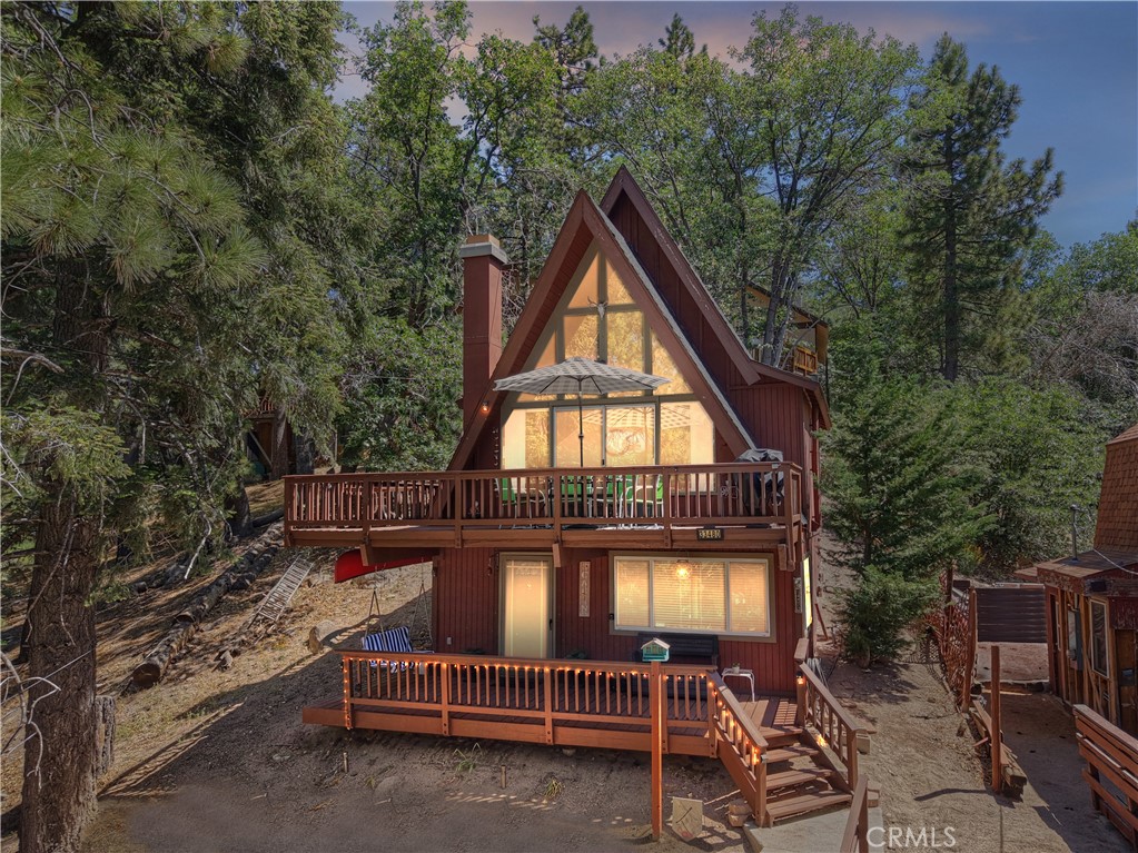 Come join the quiet, peaceful community of Green Valley Lake. Own your own piece of the mountain wilderness in this updated 2 bedroom 1 bath cabin. Enter into the cozy family room with comfortable sofas, a pellet stove and flat screen TV to enjoy an afternoon movie or games with the family. Upstairs is another space for enjoying the view of surrounding trees and access to the attached deck. This sitting area adjoins the open kitchen with a built-in corner booth for enjoying meals. The primary bedroom and bath are also off of the kitchen area. Upstairs is another loft bedroom for family or friends that stay over. Parking for 3 cars. Comes fully furnished per seller inventory. A great space at a great price. Don't miss it!