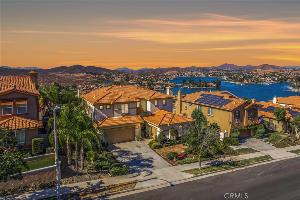One of the Most Breathtaking Canyon Lake View Homes in the Tuscany Hills Community of Lake Elsinore!
Welcome to 51 Via De La Valle, a beautifully crafted Mediterranean-style residence offering stunning, unobstructed views of Canyon Lake. Built in 2005, this expansive two-story home features 4 bedrooms, 2.5 bathrooms, and 3,493 sq ft of thoughtfully designed living space. From the moment you arrive, you’ll be captivated by the home’s architectural charm—including an arched entryway and a beautifully landscaped front yard. Inside, the layout is perfect for both everyday living and entertaining. The main level offers a formal living room with a cozy fireplace, a formal dining room, and a modern kitchen equipped with granite countertops, an oversized custom island, abundant cabinetry, and a Butler’s pantry. The kitchen opens seamlessly to a spacious family room, creating a comfortable and inviting gathering space. Upstairs, all four bedrooms are generously sized, providing comfort and flexibility for any lifestyle. The versatile upstairs retreat, currently used as a family entertainment room with a second fireplace, could easily be converted into a fifth bedroom. The luxurious primary suite is a true haven, featuring a custom walk-in closet and panoramic lake views you can enjoy year-round—including snow-capped mountains in the winter. Step outside to your resort-style backyard on a 10,890 sq ft lot, where you'll find two patio areas, mature landscaping, a custom-designed waterfall, citrus trees, and swaying palms—perfect for relaxing, entertaining, or simply taking in the peaceful surroundings. Additional highlights include a 3-car garage/Casita, central A/C, and access to the exceptional Tuscany Hills amenities, including a clubhouse, pool and spa, fitness center, tennis, pickleball and basketball courts, BBQ area, and playground. With convenient access to the 15 freeway, this home is perfectly situated for both daily commuting and weekend getaways. Don’t miss this rare opportunity to own a luxurious view home with top-tier community features in one of Lake Elsinore’s most sought-after neighborhoods!