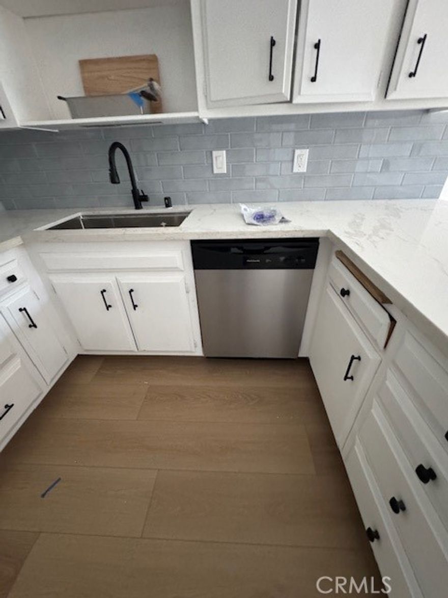 Private rear fully remodeled unit of Camarillo duplex with private yard, carport and single garage.  Primary bedroom has new remodeled bath with oversized shower.  New luxury vinyl plank flooring, baseboards, remodeled kitchen with quartz counters, subway backsplash and stainless steel sink and dishwasher.    Private garage with adjacent private covered carport.  Rear yard has large covered patio with peek-a-boo ocean view.  Available 12/15/25.