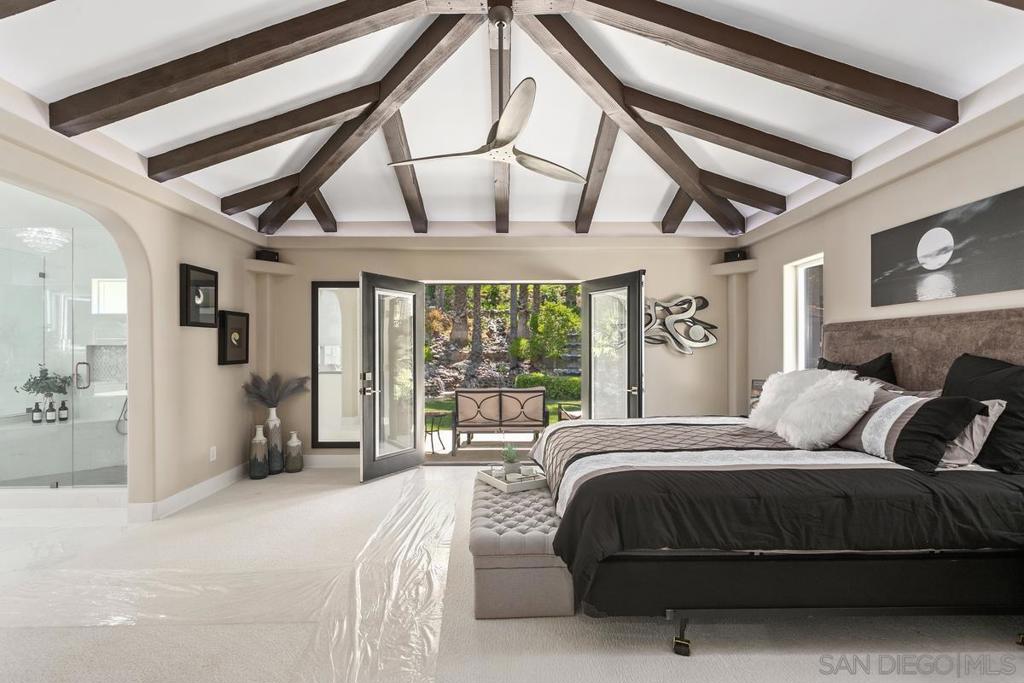 Experience a spectacular estate and versatile residence that adapts to any venue, recently completed w/ 2 one-bedroom units & a third two-bedroom aux unit with plans, recently completed solar system, a tropical paradise found. Experience this extraordinary newly constructed/renovated, 5,858 sqft single-story Equestrian Estate on 2.52 acres, with an additional attached one-bedroom, one-bath guest house w/ separate entrance that hosts friends/family, and is also perfect for maid quarters. Approach this contractor's estate along a private gated palm-lined circle drive, surrounded by luscious tropical landscape fountain, palms, and foliage. This masterfully crafted luxury retreat invites you, with an arched stone portico entry, to enjoy sculpted walls, high ceilings, and open flowing archways, connecting all gathering areas. Entertain family & friends in the formal living room featuring a stunning ledge stone fireplace. The adjacent bar/pool table/entertainment room invites the outside in through beautiful French doors. This home's hub is the gourmet cooks' kitchen w/ seated island, vegetable sink, lit shaker style cabinets, Viking appliances, double ovens & cooktop, custom butcher block counter, stainless steel sink, quartz Carrera Blanca countertops, and LEDs with large pendants. Full-size laundry/hanging closet adjacent to kitchen. Refer to supplement to discover this beautiful estate and all that it has to offer. This country estate perched atop a terraced knoll offers endless opportunities and versatility, with two ensuite bedrooms, 3rd bedroom, office/den/nursery/hobby room(4th BR), dream shop/man cave/museum, RV garage/carriage house(with plans for conversion to a 2 bed axillary unit), a charming two-story horse barn, attached 1-bed guest house, and detached 1-bed caretakers unit (perfect for rental income). The primary spa-style bedroom suite features custom steam shower w/ 24in rain head and 6 body misters, jetted spa tub, tiled walk-in shower, high beam ceilings and dome-lit cedar closet. Enjoy the spacious double vanity bath with stunning chandelier, and custom seated beauty station w/ touch screen lighted mirror, which creates a private space with dimmable control, surround music, where any ambiance can be achieved. Relax, retreat, and enjoy in your suite w/ custom ledge stone fireplace, plasma TV, and surround sound with French doors opening to a private covered patio with stunning views of a captivating river rock hillside waterfall, and tropical landscape. Discover the best of all worlds, indoor/outdoor entertaining, enjoy dining alfresco near the waterfall, pool, cabana, and built-in BBQ area. Near the kitchen hub enter a wonderfully fun venue through arched glass French doors, which open to a spacious custom theater media/entertainment room with TV, JBL speakers, surround sound Sherwin Vega system, dimmable theater sconce lighting/can lights, ceiling fan, theater style drapes/carpet, and remote control fireplace. This extraordinarily expansive property stimulates your imagination with many possibilities. The 3-car garage accommodates a weight room and exercise area. Enjoy your private charming four-stall horse & hay barn w/ tack room which has a second-story storage room(possible office/handyman workshop/quarters), and a large fenced turnout area/arena/covered corral and grooming stations. Barns are often converted to other uses/ guesthouse/ design workspace/ hobbyist space/ greenhouse/ specialized crops/ entrepreneur’s space/ breeding/ equipment/ cars/ motorcycle storage and safe area for pets. Invite the imagination and envision your project in the versatile metal automotive shop/man cave/museum 30x40ft w/ hydraulic lift, double workbench, solvent tank, bathroom, and spacious lounge/display area. This expansive compound also offers a 20x40ft, completely enclosed modern carriage house, perfect for an extra large RV/Car collection/equipment/auxiliary studio/hobbyist building with tile roof, power station, a...