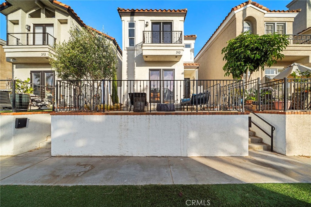 Welcome to 310 18th Street - an elegantly remodeled and fully furnished beachside residence in the heart of Downtown Huntington Beach. Just moments from the shoreline, Pacific City, and the iconic Huntington Beach Pier, this detached single-family home blends timeless design with modern convenience across 2,462 square feet of coastal-inspired living space. Step inside into a light-filled living area featuring porcelain wood tile flooring and a seamless indoor-outdoor connection to the front patio with ocean breezes - perfect for entertaining or soaking in the coastal atmosphere. The open-concept layout flows effortlessly from the living room to the dining area and kitchen, ideal for relaxed gatherings or elevated everyday living. This thoughtfully designed home features three spacious bedrooms and three and a half bathrooms, including a convenient half bath on the first floor - perfect for guests. Upstairs, each full en suite bathroom has been custom-designed with its own distinctive finishes, while the primary suite offers a peaceful retreat. After a day at the beach, rinse off in your private outdoor shower before heading up to the rooftop deck, where coastal breezes and sunset skies invite relaxation. A two-car garage provides secure parking and extra storage. Offered fully furnished, this home is move-in ready and perfect as a primary residence, second home, or luxury rental. Live the ultimate surfside lifestyle - just three blocks from the beach, world-class surf, trendy shops, and acclaimed restaurants. This is Huntington Beach living at its finest.