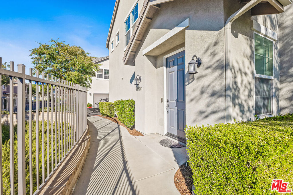 Welcome to this bright and beautifully upgraded 2-bedroom, 2-bathroom end-unit townhouse in the desirable Brookside Walk community of Valencia. Situated on the top corner above its own private 2-car garage, this home offers a spacious, open layout with vinyl plank floors throughout the main living areas and front bedroom. The kitchen boasts stainless steel appliances, crisp white cabinetry, and a breakfast bar that flows seamlessly into the dining and living areas each with tranquil views of Heritage Park. Step onto your private balcony and take in the serene vistas of the park, mountains, and majestic oak trees. The primary suite includes a generous walk-in closet and en-suite bath with dual vanities, while a newer full-size stackable washer and dryer provide modern convenience.Set within Valencia's sought-after Creekside neighborhood, residents enjoy resort-style amenities including a pool, spa, and scenic biking trails. Just minutes from Bridgeport Park, award-winning schools, shopping, dining, and Valencia's famous paseos, this home perfectly blends comfort, convenience, and lifestyle. Don't miss this exceptional opportunity!
