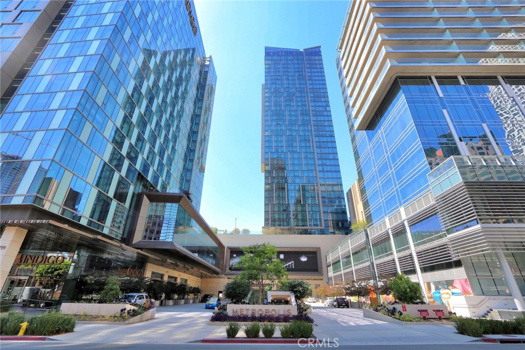 Experience elevated urban living in this sleek and spacious 1-bedroom, 1.5-bathroom condo in the prestigious Metropolis Tower 1. With wide open south-facing views, this high-rise residence showcases breathtaking vistas of the Downtown LA skyline, Griffith Observatory, and even the Hollywood Sign—visible from every room through expansive floor-to-ceiling windows that fill the space with natural light.
The thoughtfully designed interior features an open-concept layout with high-end finishes throughout, including Caesarstone countertops, custom cabinetry, premium Bosch appliances, and warm oak wood flooring that adds an elegant touch. In-unit laundry and custom window shades provide added comfort and convenience.
Residents of Metropolis enjoy exclusive access to resort-style amenities, including a sparkling pool and spa, fully equipped fitness center, steam room, private lounges, a screening room, and beautifully designed community spaces perfect for working remotely or entertaining. The building also offers 24-hour security, front desk service, and high-speed WiFi included.
Located in the heart of the Financial District, you're just minutes from Koreatown, Little Tokyo, and Crypto.com Arena, with the best of downtown dining, shopping, and entertainment right outside your door. Additional monthly parking is available across the street. This is modern city living at its finest—refined, connected, and effortlessly luxurious.
