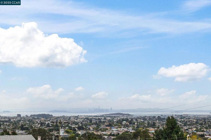 Jaw-dropping panoramic water and San Francisco city skyline views from this stylish 2-bedroom bungalow! Step inside and you’ll instantly feel the vibe—natural light floods through big picture windows, highlighting the original hardwood floors, fresh paint, and sleek recessed lighting. The open-concept living and dining areas flow right into the modern, updated kitchen—perfect for dinner parties, game nights, or quick bites before heading out to explore. Wake up to sunshine in the two bright bedrooms and start your day in the updated bathroom. But the real magic happens outside—the wraparound front porch is the spot for your morning coffee, golden-hour cocktails, or late-night DoorDash with a view. The spacious backyard is a blank canvas waiting for your creativity: think string lights, a cozy fire pit, or even a raised veggie garden. Plus, there’s plenty of potential to expand if you need more space down the road. Just minutes to Alvarado Park and Wildcat Canyon for hiking, biking, and weekend adventures—this home perfectly blends city access, nature, and serious chill. More than just a home, it’s a lifestyle—and it’s ready for you to make it yours.